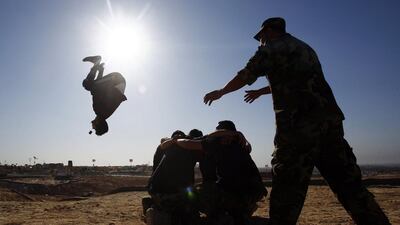 Fighters from the Iraqi Imam Ali Brigade take part in a training exercise in Iraq's central city of Najaf on March 7, 2015, ahead of joining the military operation to retake Tikrit. Haidar Hamdani/AFP Photo