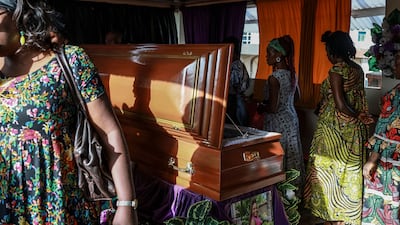 Relatives with the body of Geraldine Buweh Atsie, a victim of femicide, inside a chapel at Jamot Hospital in Yaounde, Cameroon. AFP