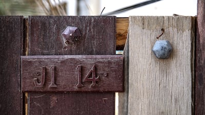 This wooden main entrance door is the entrance to a farm