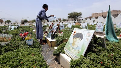 A Yemeni boy sprinkles water in a cemetery in Sanaa, Yemen on August 8, 2017, near the grave of a child allegedly killed in the ongoing conflict. Yahya Arhab / EPA