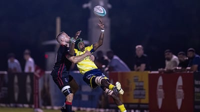 Martin Mangwiro of Dubai Hurricanes is tackled by Michael Stubbs of Dubai Exiles.