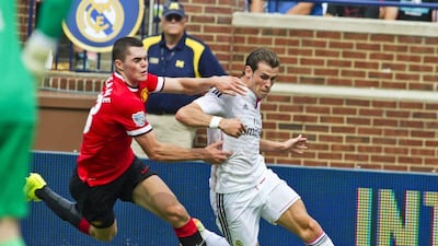 Real Madrid's Gareth Bale, right, dribbles away from Manchester United's Michael Keane, left, during their match on Saturday at the International Champions Cup in the US. Tony Ding / AP