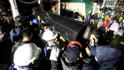 Workers carry a tube during the search for students at Enrique Rebsamen school after an earthquake in Mexico City. Edgard Garrido / Reuters