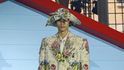 In head-to-toe florals, a model presents a look from Louis Vuitton's autumn/winter 2022 collection. Reuters
