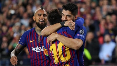 Lionel Messi celebrates with Luis Suarez. Catherine Ivill / Getty Images