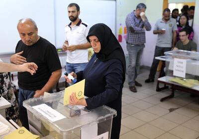 A woman votes at a polling station in a school during elections in Istanbul,Turkey, June 24, 2018. Goran Tomasevic / Reuters
