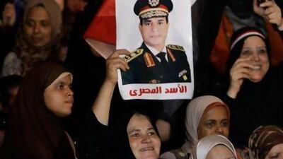 Opponents of ousted president Mohammed Morsi hold up a poster of the Egyptian defence minister, Gen Abdel Fattah El Sisi, with an Arabic caption that reads, ‘The lion of Egypt’.