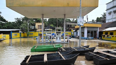 Makeshift boats are seen parked next to a petrol pump following heavy rain in Ghatal, Paschim Medinipur district, India.
