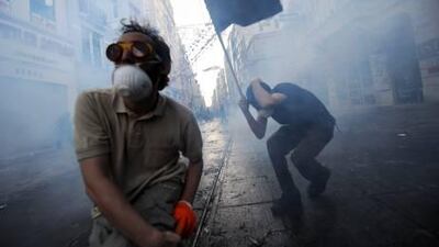 Protestors clash with Turkish riot policemen during a protest that began to object the demolition of Taksim Gezi Park in Istanbul, 2013. Bulent Kilic / AFP