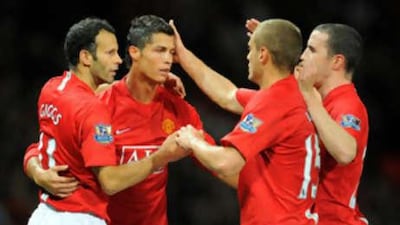 Cristiano Ronaldo, second from left, is congratulated by his Manchester United teammates on making a goalscoring return in his first start for the side after three months out with an ankle injury.