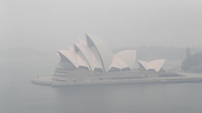 Smoke haze is seen over Sydney Harbour with the Opera House hardly visible. Getty Images