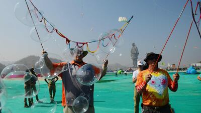 Australian performers make soap bubbles to entertain schoolchildren during the event. AFP