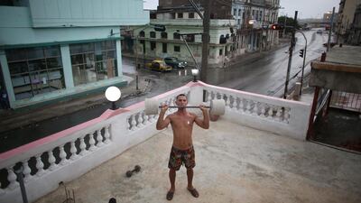 Painter Dian Peralta, 24, exercises on the roof of his home in downtown Havana, Cuba. Alexandre Meneghini / Reuters
