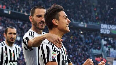 Argentinian forward Paulo Dybala (R) of Juventus celebrates after scoring the 1-0 goal during Italian Serie A soccer match between Juventus FC and Hellas Verona at the Juventus Stadium in Turin, Italy, 06 January 2016. Di Marco / EPA