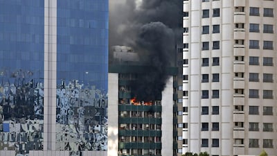 Flames and smoke could be seen pouring from the building on Abu Dhabi’s Airport Road on Monday.