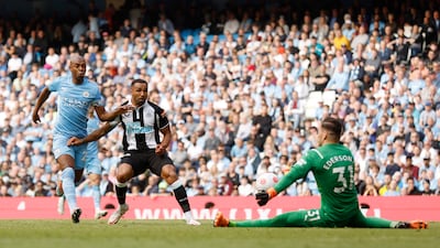 Newcastle substitute Callum Wilson sees a shot saved by City goalkeeper Ederson. Reuters