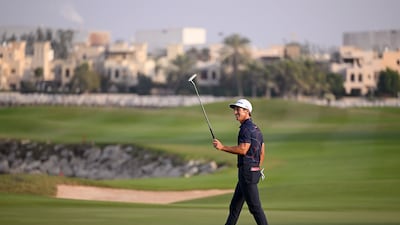 Thorbjorn Olesen raises his putter as he celebrates victory on the 18th green. Getty Images