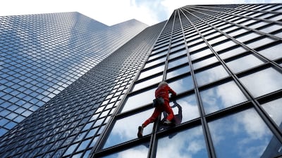 French 'Spiderman' Alain Robert during his unsuccessful attempt to climb the TotalEnergies skyscraper to highlight the fuel and energy crisis, in La Defence, near Paris. Reuters