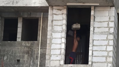 A man works out inside an under-construction building in the Dharavi slum. AFP