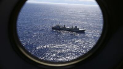 HMAS Success scans the southern Indian Ocean, near the coast of Western Australia, as a Royal New Zealand Air Force P3 Orion flies over, while searching for missing Malaysia Airlines Flight MH370. Rob Griffith / AP Photo