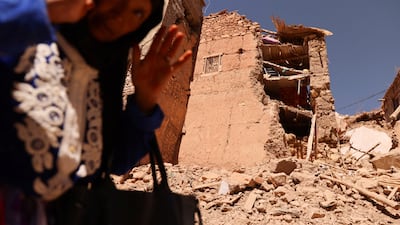 A woman gestures in front of a partly destroyed mosque in Adassil, Morocco. Reuters