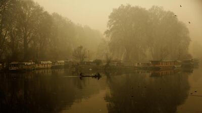 A Kashmiri boatman rows on the Dal Lake during a foggy morning in Srinagar, India. Mukhtar Khan / AP Photo