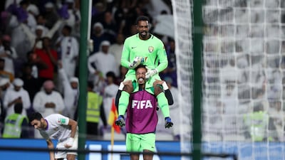Al Ain's Khalid Essa is hoisted up after saving two penalties in the shoot-out against Wellington.