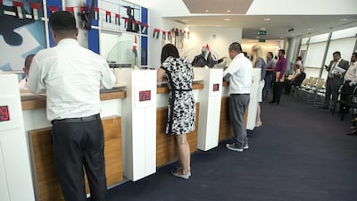 People wait to be served at the Dubai Multi Commodities Centre customer service area. Reem Mohammed / The National