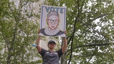 A protester holds a sign with Ginsburg's picture during an abortion rights demonstration in New York. AP