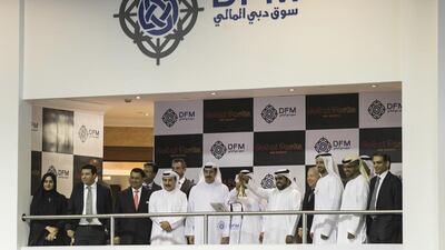 Raed Al Nuaimi, the chief executive of Dubai Parks and Resorts, rings the bell to kick off its IPO on the DFM. Reem Mohammed / The National