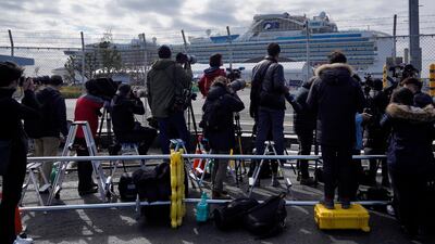 Members of the media work near the Diamond Princess cruise at the Daikoku Pier Cruise Terminal in Yokohama. EPA