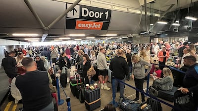 Passengers queue outside Manchester Airport's Terminal 1 after Sunday's power cut. Reuters