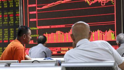 Investors monitor stock data on an electronic board at a securities brokerage house in Beijing, China, on August 26, 2015. EPA