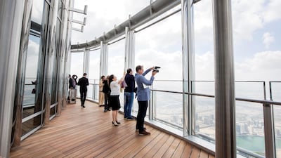 People get the first glimpse of the view from the 152nd floor's open deck at The Lounge. Photo: Leslie Pableo for The National