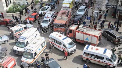 First aid responders work near a struck building in Sidon. AFP