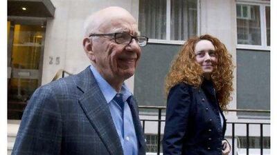 Rupert Murdoch leaves his flat with Rebekah Brooks, who resigned on Friday as chief executive of News International.