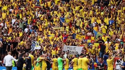 Players of Romania celebrate with their supporters after winning the Group E match against Ukraine. EPA