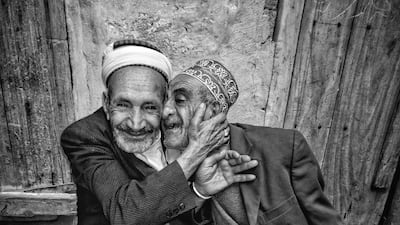 The Hug of Reconciliation photo of two brothers in their 70s embracing after years of a bitter dispute over a plot of land which won Ali Alsonidar the Middle East Insitute's 2019 photo competition. Ali Alsonidar