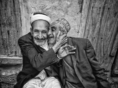 The Hug of Reconciliation photo of two brothers in their 70s embracing after years of a bitter dispute over a plot of land which won Ali Alsonidar the Middle East Insitute's 2019 photo competition. Ali Alsonidar