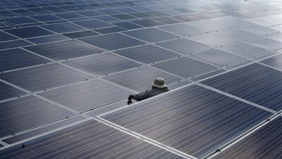 A worker at a solar power plant. Saudi Arabia's Acwa is planning a number of solar and wind power facilities. Athit Perawongmetha/Reuters