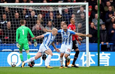 Huddersfield Town's Aaron Mooy, centre, celebrates his goal against Manchester United. Nigel French / PA