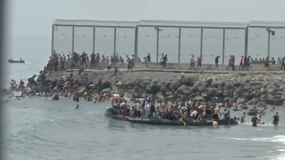 Migrants arrive in Spanish territory in North Africa after swimming across the Ceuta border from Morocco. Reuters