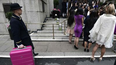 A hotel porter handles luggage as Miss World 2014 finalists enter a hotel during a publicity launch in central London November 25, 2014. The final of the 2014 edition of the pageant will take place in London on December 14. Toby Melville / Reuters