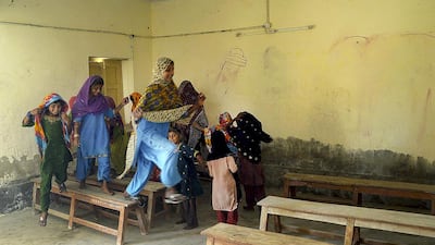 Pakistani children try teach one another or play in classrooms that have been abandoned by teachers. Riswan Tabassum / AFP