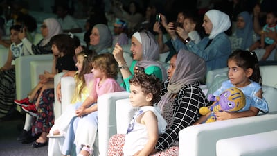 Parents and their children watch a performance at one of the festival's many shows and theatre productions. Photo: Pawan Singh / The National