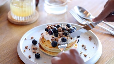 On the breakfast menu: buttermilk pikelets with coconut husk maple, buffalo ricotta and almonds. Chris Whiteoak / The National