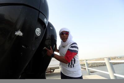Yousef Baroun points out the bullet holes in his vessel after he came under fire while searching for tuna in the Gulf of Oman. Satish Kumar for the National