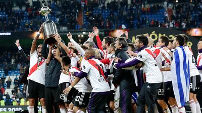 Marcelo Gallardo, coach of Argentina's River Plate, second from left, celebrates with the trophy after his team defeated Argentina's Boca Juniors. AP Photo