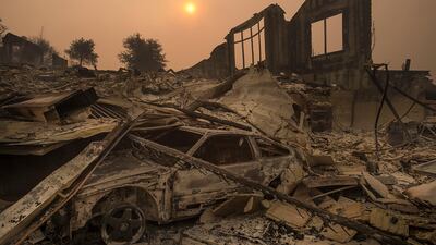 The sun rises through a cloud of smoke after a wildfire swept through the area in Sonoma County in California. Paul Kitagaki Jr. / The Sacramento Bee via AP