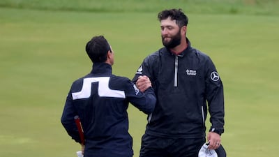 Jon Rahm of Spain shakes hands with Viktor Hovland of Norway on the 18th green. Getty